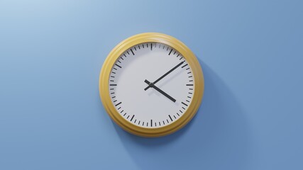 Glossy orange clock on a blue wall at nine past four. Time is 04:09 or 16:09