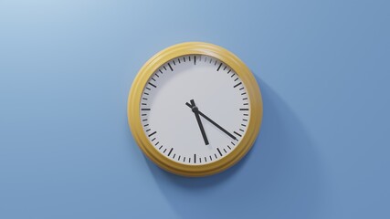 Glossy orange clock on a blue wall at twenty-one past five. Time is 05:21 or 17:21
