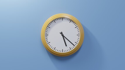 Glossy orange clock on a blue wall at twenty-two past five. Time is 05:22 or 17:22