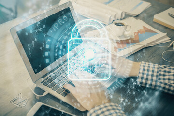 Obraz premium Double exposure of lock icon with man working on computer on background. Concept of network security.