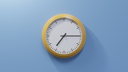 Glossy orange clock on a blue wall at quarter past seven. Time is 07:15 or 19:15
