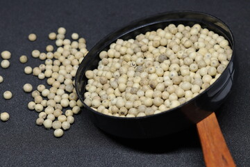 White pepper grains isolated on black background