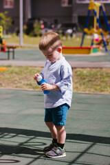 little boy yfledftn blowing bubbles on the playground