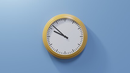 Glossy orange clock on a blue wall at fifty-two past nine. Time is 09:52 or 21:52