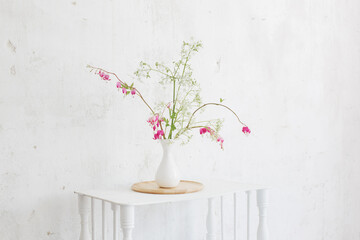 flowers in vase on background white wall