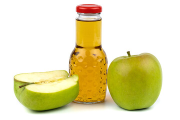 Apple juice bottle. Nearby are juicy, beautiful apples.