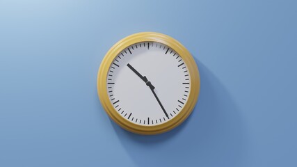 Glossy orange clock on a blue wall at twenty-five past ten. Time is 10:25 or 22:25
