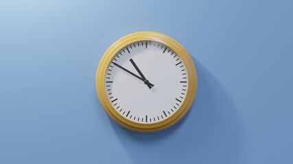 Glossy orange clock on a blue wall at ten to eleven. Time is 10:50 or 22:50