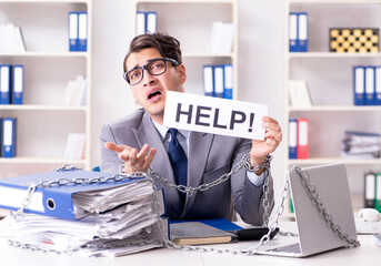 Busy employee chained to his office desk