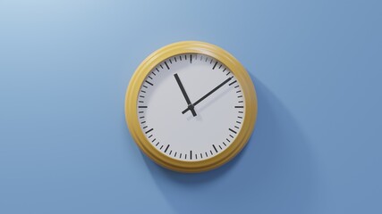 Glossy orange clock on a blue wall at nine past eleven. Time is 11:09 or 23:09