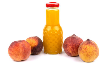 Peach juice bottle. Nearby are juicy, beautiful peaches.