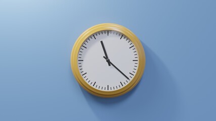 Glossy orange clock on a blue wall at twenty-two past eleven. Time is 11:22 or 23:22