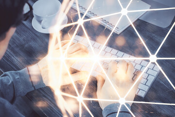 Social network theme hologram with businessman working on computer on background. Multi exposure.