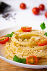 Spaghetti with cherry tomatoes and cheese close-up