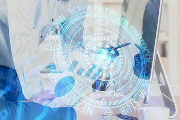 Double exposure of technology hologram with man working on computer background. Concept of big data.