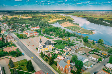 Rechytsa, Belarus. Aerial View Of Residential Houses, River Dnieper And Holy Assumption Cathedral In Sunny Summer Day. Top View. Drone View. Bird's Eye View