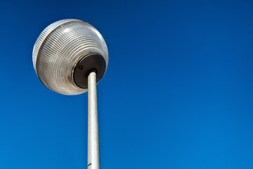 A streetlight illuminates more of a part of the street