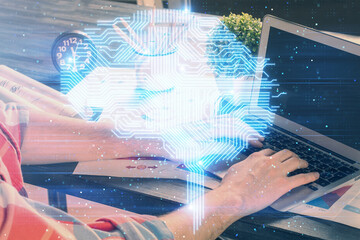 Man with computer background with brain theme hologram. Concept of brainstorm. Double exposure.