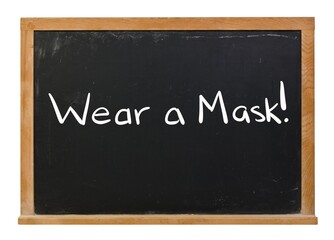 Obraz premium Wear a mask written in white chalk on a black chalkboard isolated on white
