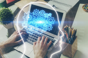 Businessman with computer background with brain theme hologram. Concept of brainstorm. Multi exposure.