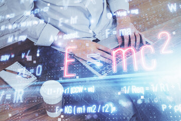 Science formula hologram with man working on computer on background. Education concept. Double...
