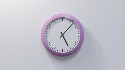 Glossy pink clock on a white wall at seven past five. Time is 05:07 or 17:07