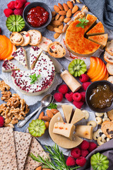Plate of organic raw vegan cheese, snacks, nuts, fruits, berries