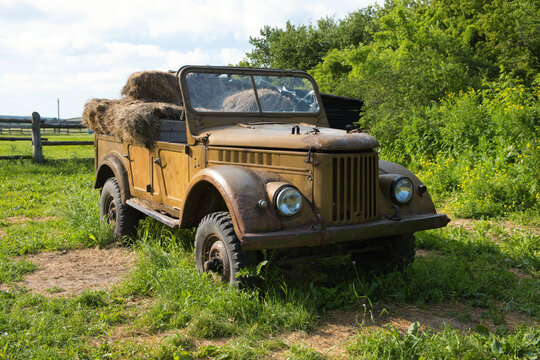 rusty entourage Soviet military jeep gaz 69 with hay