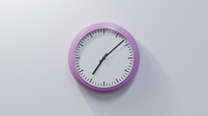 Glossy pink clock on a white wall at eight past seven. Time is 07:08 or 19:08