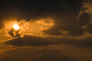 The sun at sunset and, slightly covering it, clouds (option 2)