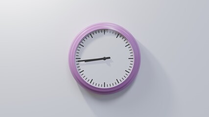 Glossy pink clock on a white wall at forty-four past eight. Time is 08:44 or 20:44
