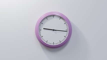 Glossy pink clock on a white wall at sixteen past nine. Time is 09:16 or 21:16