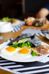 black pita on a white plate. Serving a Mediterranean breakfast. national street food. Fresh tasty ingredients.