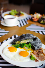 black pita on a white plate. Serving a Mediterranean breakfast. national street food. Fresh tasty ingredients.