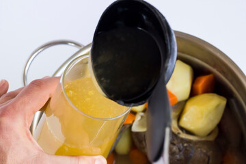 Beef marrow bone boiled in stainless steel pan with vegetables.The Sacrifice Festival Food preparation.