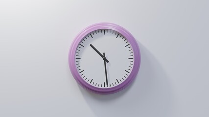 Glossy pink clock on a white wall at twenty-nine past ten. Time is 10:29 or 22:29