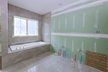 Under construction new bathtub remodeling a home bathroom, plumbing pipe for new sinks