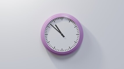 Glossy pink clock on a white wall at fifty-two past ten. Time is 10:52 or 22:52