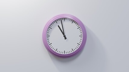 Glossy pink clock on a white wall at fifty-eight past ten. Time is 10:58 or 22:58