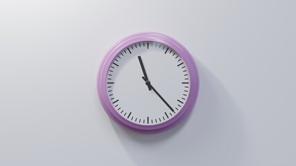 Glossy pink clock on a white wall at twenty-three past eleven. Time is 11:23 or 23:23