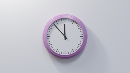 Glossy pink clock on a white wall at fifty-three past eleven. Time is 11:53 or 23:53