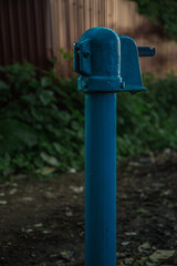Old blue water pump in summer