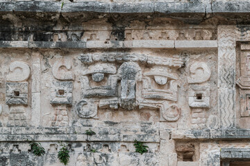 Close-up on the pre-columbian carvings on the walls of one of the building at the Chichen-Itza Mayan site, Mexico.