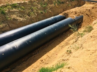 new insulated water pipes in the trench construction site . urban sewerage infrastructure