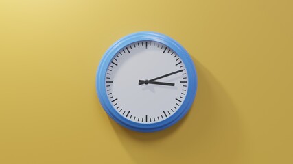 Glossy blue clock on a orange wall at twelve past three. Time is 03:12 or 15:12