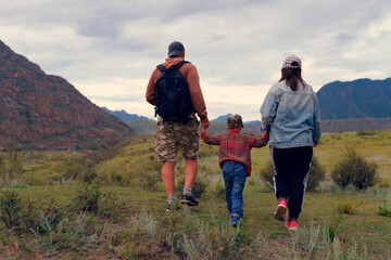 family walking in the mountains