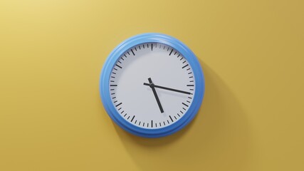 Glossy blue clock on a orange wall at seventeen past five. Time is 05:17 or 17:17