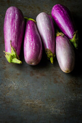 Fairy Tale Eggplants on a dark surface