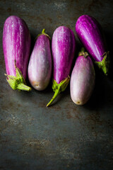 Fairy Tale Eggplants on a dark surface