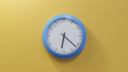 Glossy blue clock on a orange wall at twenty-two past six. Time is 06:22 or 18:22